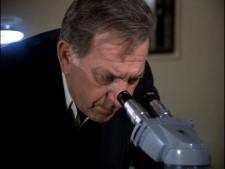 Jack Klugman as Quincy looking in a microscope Jack Klugman as Quincy looking in a microscope